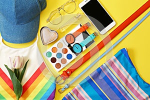 Flat lay composition with clothes and accessories on color background