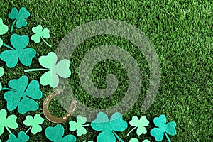 Flat lay composition with clover leaves on grass, space for text. St. Patrick`s Day celebration