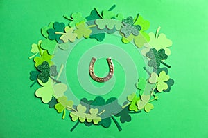 Flat lay composition with clover leaves and horseshoe on background. St. Patrick`s day