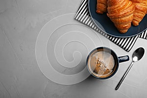 Flat lay composition with coffee and croissants on grey table