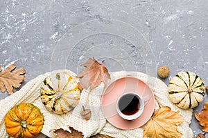 Flat lay composition with colorful Autumn cup of coffee and leaves on a color background. top view