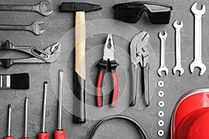 Flat lay composition with construction tools on grey background