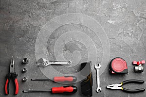 Flat lay composition with construction tools on grey, space for text