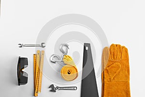 Flat lay composition with construction tools and safety equipment on white background