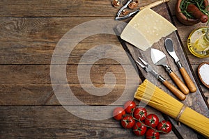 Flat lay composition with cooking utensils and fresh ingredients on wooden table. Space for text