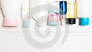 Flat lay composition with cosmetic and cream bottles on wooden background. Beauty products concept with copy space