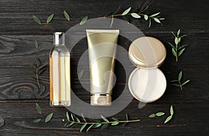 Flat lay composition with cosmetic products on black table