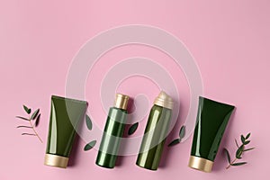 Flat lay composition with cosmetic products and leaves on background. Space for text
