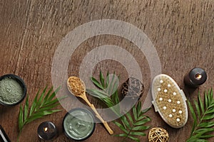 Flat lay composition with cosmetic products on wooden background, space for text. Spa body wraps