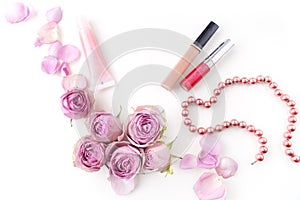 Flat lay composition with cosmetics and pink rose flowers. Top view