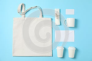 Flat lay composition with cotton bag, paper cups and office supplies
