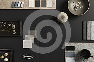 Flat lay composition of creative black architect mood board with samples of building, textile and natural materials and personal.