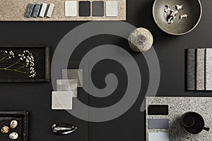 Flat lay composition of creative black architect mood board with samples of building, textile and natural materials and personal. photo