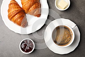 Flat lay composition with cup of coffee and croissants