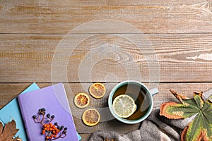 Flat lay composition with cup of hot drink on wooden table. Cozy autumn atmosphere