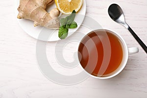 Flat lay composition with cup of tea on white wooden background. Cough remedies