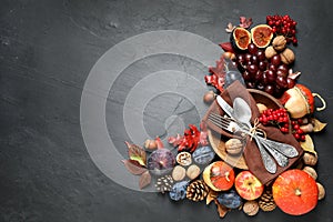 Flat lay composition with cutlery, autumn vegetables and fruits on grey background. Happy Thanksgiving day