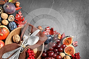 Flat lay composition with cutlery, autumn vegetables and fruits on grey background. Happy Thanksgiving day