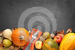 Flat lay composition with cutlery, autumn vegetables and fruits on grey background. Happy Thanksgiving day