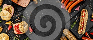 Flat lay composition of delicious hot dogs and sandwiches with different toppings on the dark background