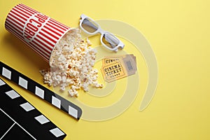 Flat lay composition with popcorn on yellow background. Space for text