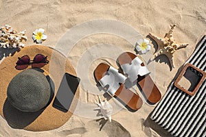 Flat lay composition with different  accessories on sand