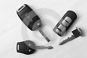 Flat lay composition with different car keys on light background