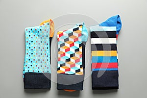 Flat lay composition with different colorful socks on gray background