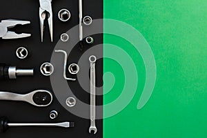 Flat Lay Composition With Different Construction Tools on Black and Green Background. Top View of Checklist and Working Tools,