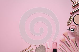 Flat lay composition with different cosmetic products on pink background. Space for text