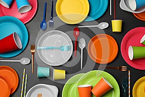 Flat lay composition with different disposable tableware on black background