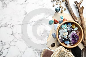 Flat lay composition with different gemstones on marble background. Space for text