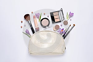 Flat lay composition with different makeup products and beautiful flowers on white background