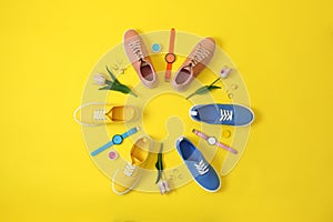 Flat lay composition with different sneakers and accessories on color background.