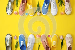 Flat lay composition with different sneakers and accessories on color background, space for text.