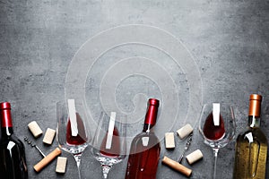 Flat lay composition with different wines on grey background photo