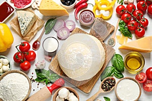 Flat lay composition with dough and fresh ingredients for pizza