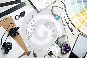 Flat lay composition with drawing of jewelry on grey table. Designer`s workplace