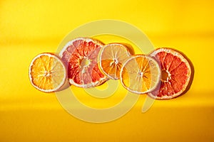 Flat lay composition with dry oranges on orange background and windowlight