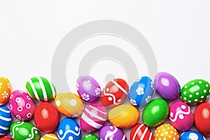 Flat lay composition with Easter eggs on color background. Frame made of decorated eggs. Top view with place for text