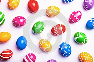 Flat lay composition with Easter eggs on light background. Frame made of decorated eggs. Top view