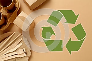 Flat lay composition of eco friendly products and recycling symbol on beige background