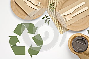 Flat lay composition of eco friendly products and recycling symbol on white background