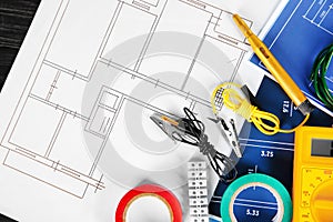 Flat lay composition with electrical tools on house plans