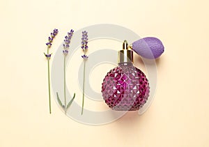 Flat lay composition with elegant perfume and beautiful flowers on background