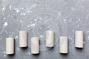 Flat lay composition with empty toilet paper rolls and space for text on color background. Recyclable paper tube with