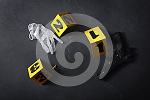 Flat lay composition with evidences and crime scene markers on black background photo