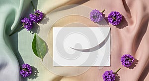 Delicate purple flowers and soft fabric with a blank card and shadow