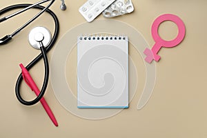 Flat lay composition with female gender sign and stethoscope on beige background. Women`s Health concept