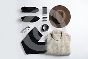 Flat lay composition with female winter clothes on white